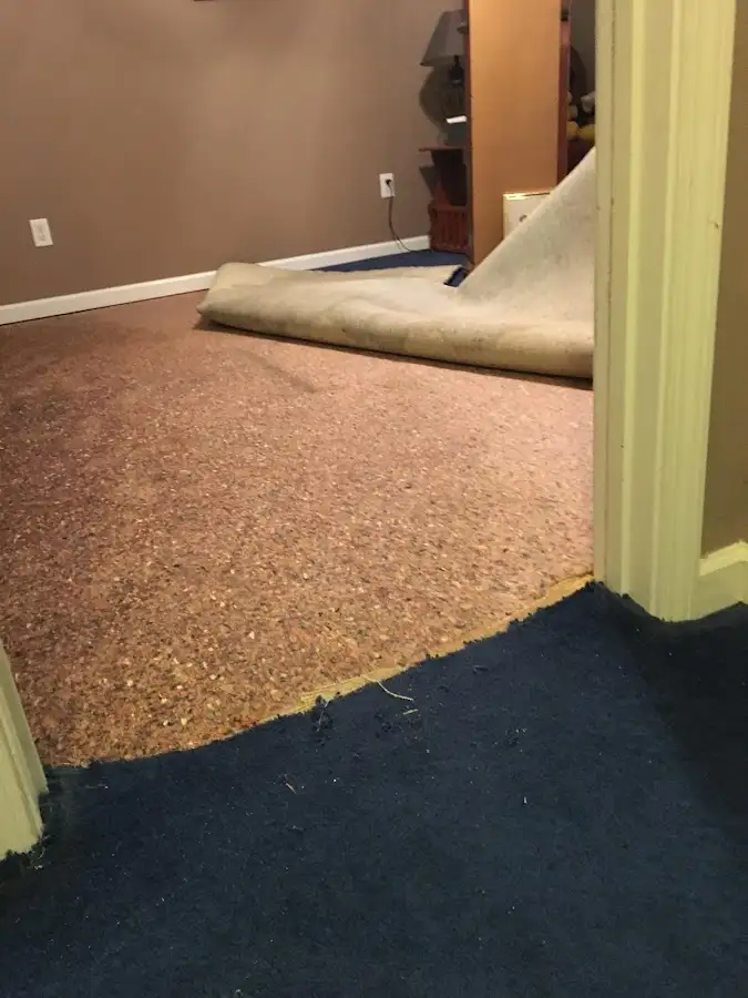 Carpet pad removal revealing water damage during Water Mitigation Services in Shreveport